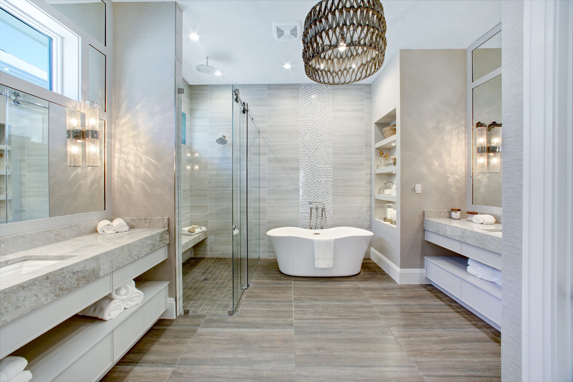 Luxury spa bathroom with freestanding tub, dual vanities, and walk-in shower