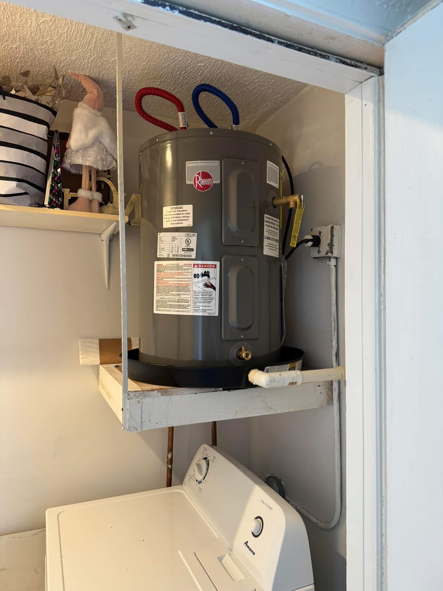 Rheem Performance water heater mounted in utility closet above washing machine